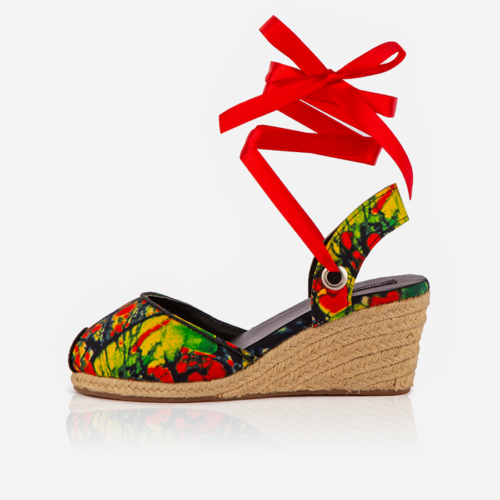 A red print Gaia espadrille sandal with a jute-wrapped wedge heel and a red ankle tie.