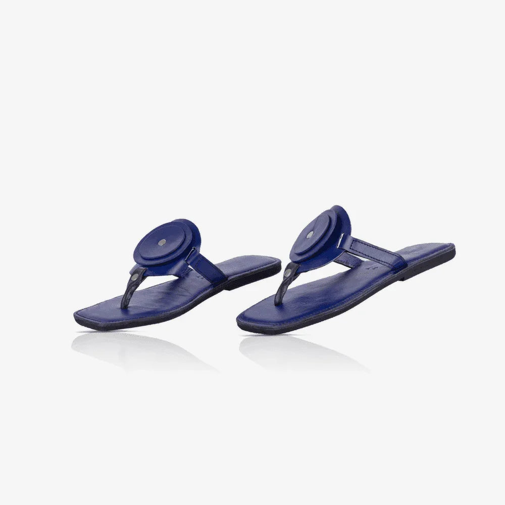 Image of a pair of blue handmade leather flat sandals with a circle design produced by Australian brand Miriam Bella