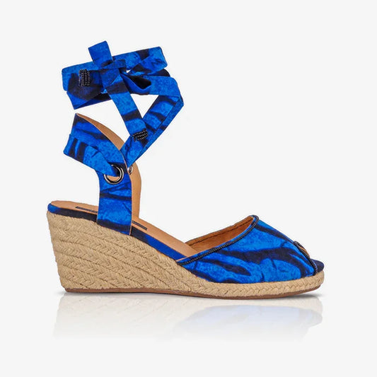 Blue wedge sandal with espadrille sole on a white background