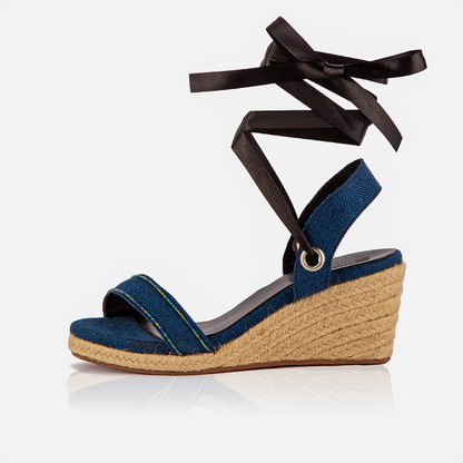 A pair of blue open-toed platform espadrilles with black straps and a wedge heel, featuring a  leather lining