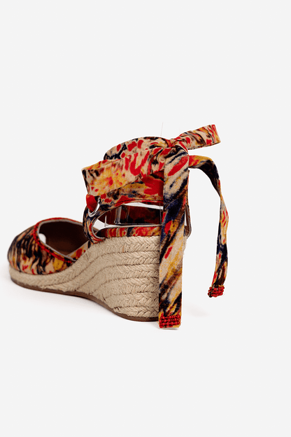 Multicolored wedge sandal with espadrille sole on a white background