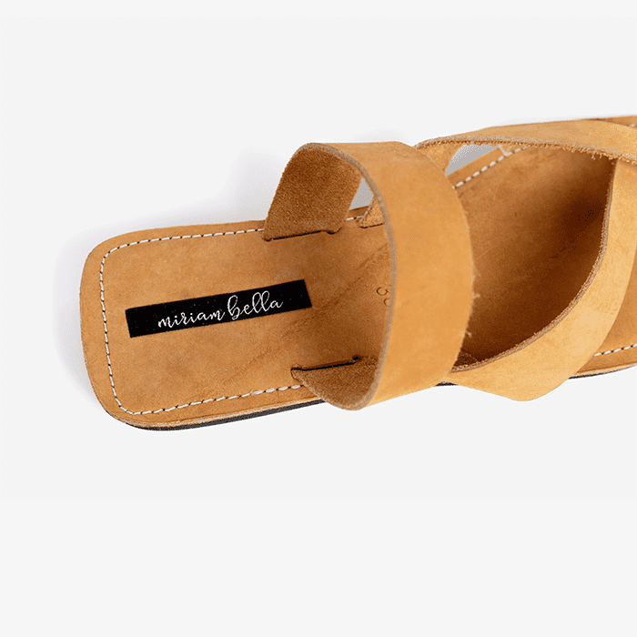 Image of tan women's leather sandals with flat cross strap, produced by Australian brand Miriam Bella