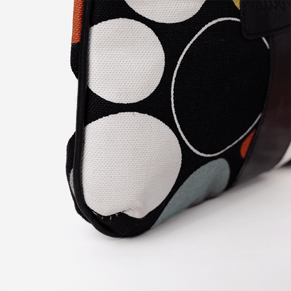 Close-up of a fabric pouch with circular patterns on a white background