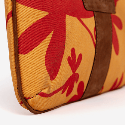 Close-up of a bag with red floral patterns on a yellow background