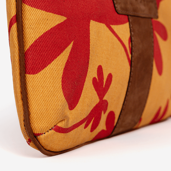 Close-up of a bag with red floral patterns on a yellow background