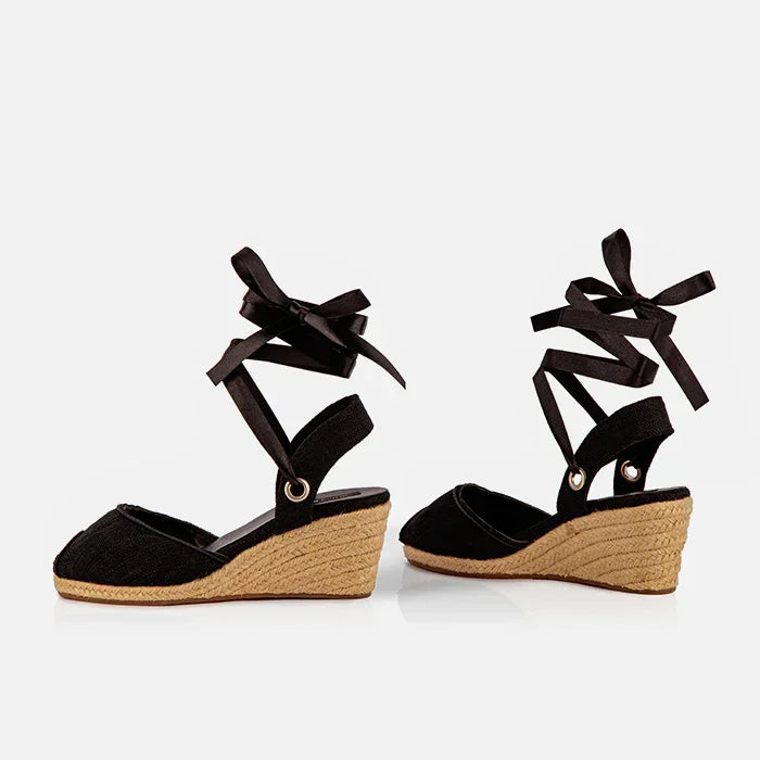 Gaia black canvas closed toe espadrille wedge heels shown at an angle with jute wedge and ribbon ties.