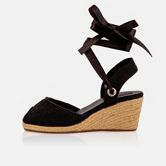 Single Gaia black canvas closed toe espadrille wedge heel with black ribbon ankle tie and jute wedge.