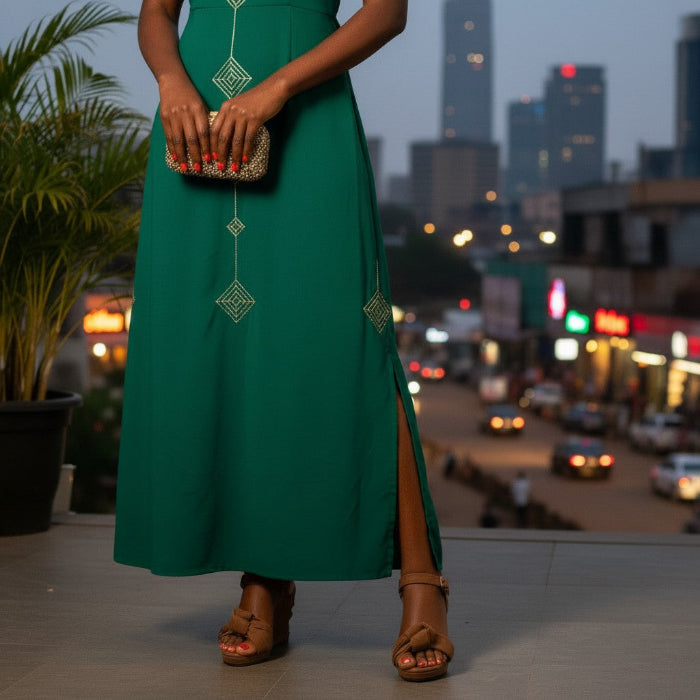 Person wearing a green dress and brown espadrille wedge sandals with a cityscape in the background