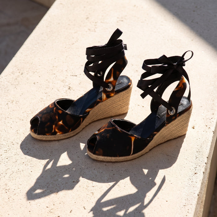 Gaia Midnight Flame women’s espadrille wedge sandals front view with printed canvas and ankle ties on a stone window ledge