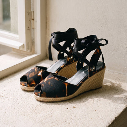 Gaia Midnight Flame women’s espadrille wedge sandals front view with printed canvas and ankle ties on a stone window ledge