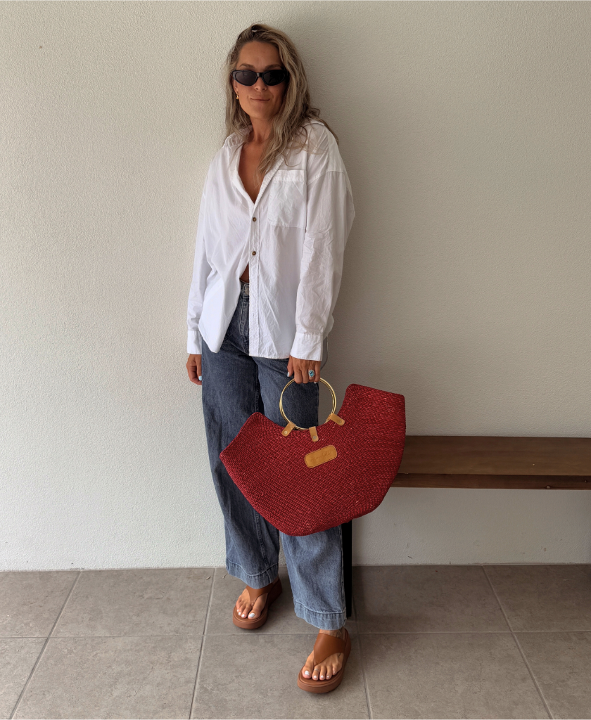 Miriam Bella handwoven seagrass beach bag styled in a real-life outdoor setting.