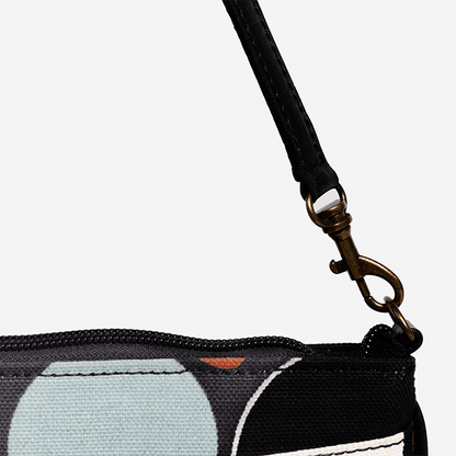 Close-up of a black strap with a metal clasp on a product with a white background