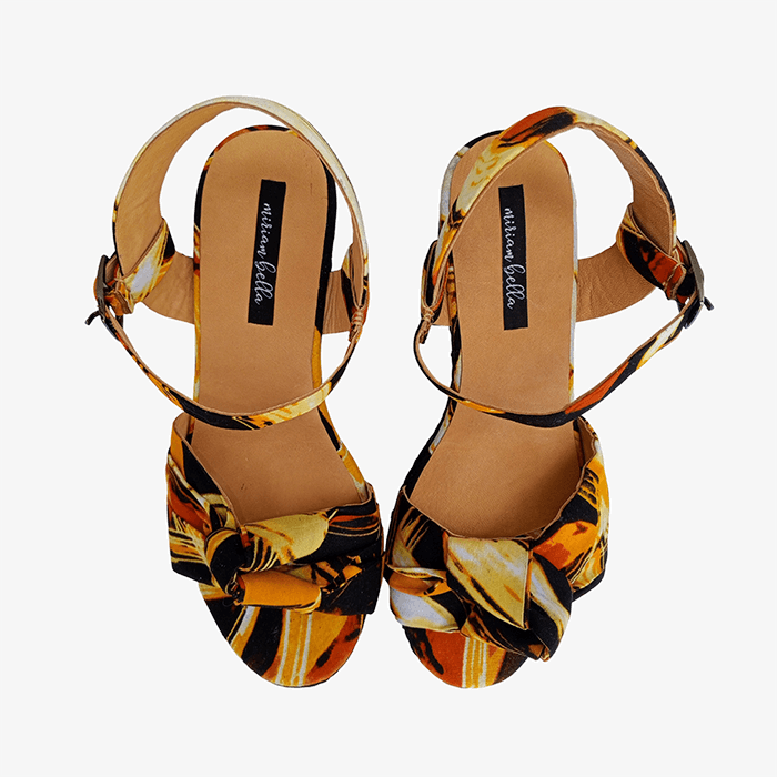 Pair of multicolored sandals with a brand label on a white background