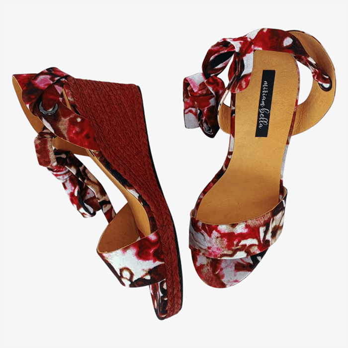 Pair of floral high-heeled shoes on a white background