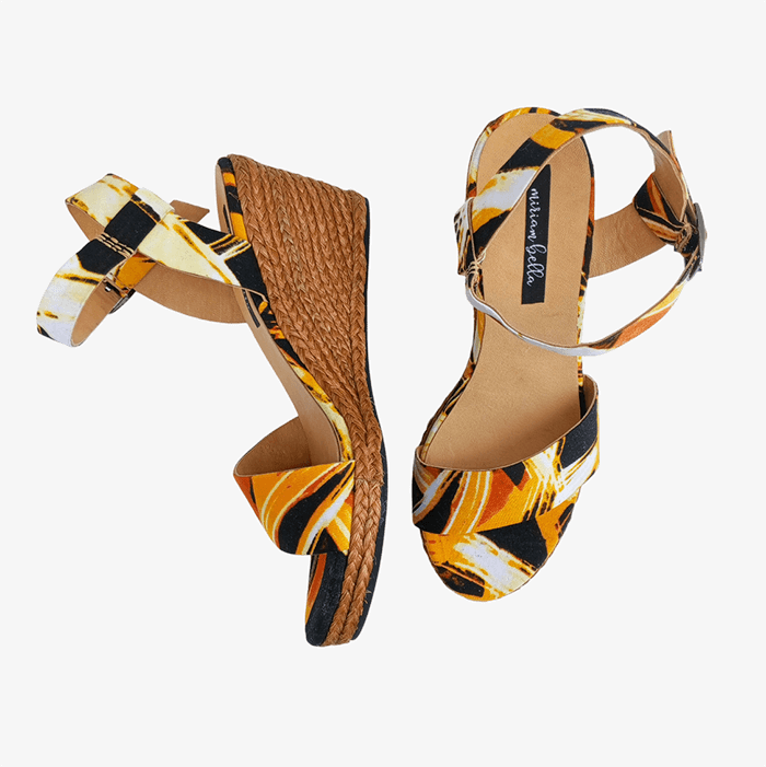 Pair of high-heeled sandals with a colorful pattern on a white background