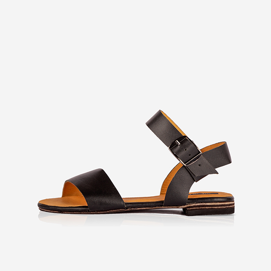 Black Women’s Leather Ankle Strap Flat Sandals on a white background
