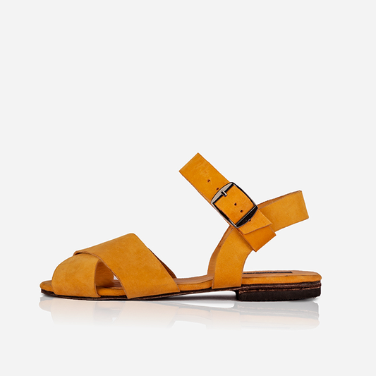 Ochre Women’s Leather Cross Strap Flat Sandals with a buckle on a white background